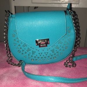 Teal crossbody purse with Aztec cutouts